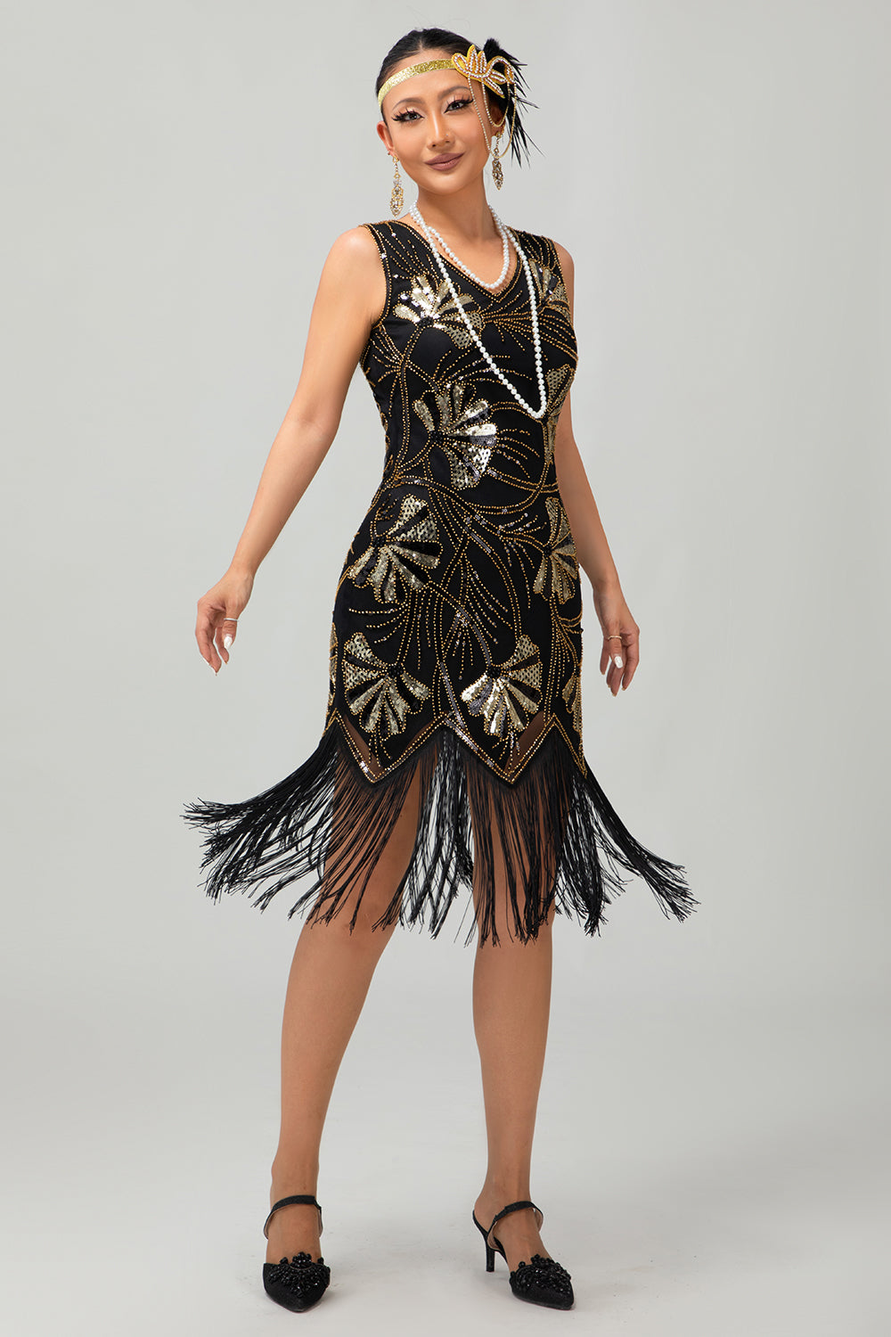 Robe noire scintillante à franges dorées des années 1920