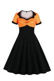 Robe noire à pois swing des années 50 à manches courtes