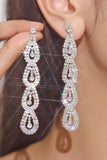 Boucles d’oreilles longues en strass argent