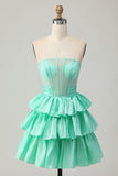 Robe de cocktail verte trapèze bustier à volants et perles avec nœud
