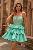 Robe de cocktail verte trapèze bustier à volants et perles avec nœud