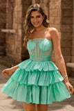 Robe de cocktail verte trapèze bustier à volants et perles avec nœud