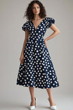 Robe à pois bleu marine et blanc à pois avec manches bouffantes