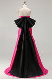 Robe de soirée longue en satin fuchsia coupe bustier à décolleté cabriolet avec grand nœud