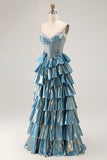 Robe de soirée longue trapèze bleu métallisé à corset ornée de perles