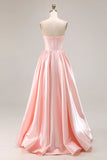 Robe de soirée longue rose en satin à corset et décolleté cœur ornée de perles