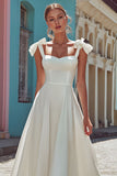 Robe de mariée midi trapèze à bretelles spaghetti blanches avec noeud