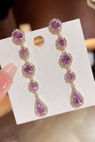 Boucles d’oreilles longues en forme de strass violets scintillants