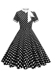 Robe à pois noirs à col haut avec un nœud A Line des années 1950