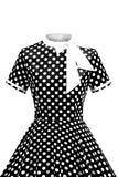Robe à pois noirs à col haut avec un nœud A Line des années 1950