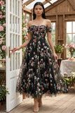 Robe d'invitée de mariage midi noire tulle ligne A bustier floral épaules dénudées appliqué