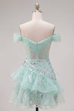 Robe de balles à la fine avec corset menthe et paillettes à l’épaule dénudée