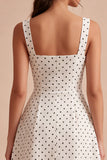 Robe à pois midi à bretelles blanches et noires