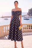 Robe midi en ligne A à fleur vert marine décollée sur l’épaule avec lacet dans le dos