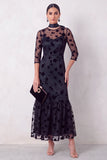Robe invitée mariage midi noire coupe sirène, à col rond illusion, détails floraux, volants et manches 3/4