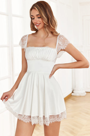 Une robe de cocktail blanche à col carré avec dentelle