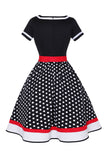 Robe noire à col V à pois des années 50