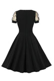 Robe noire swing des années 50 à manches courtes