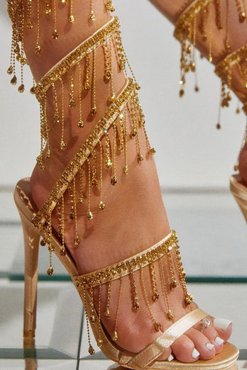 Sandales dorées à talons hauts à bretelles scintillantes avec pompon